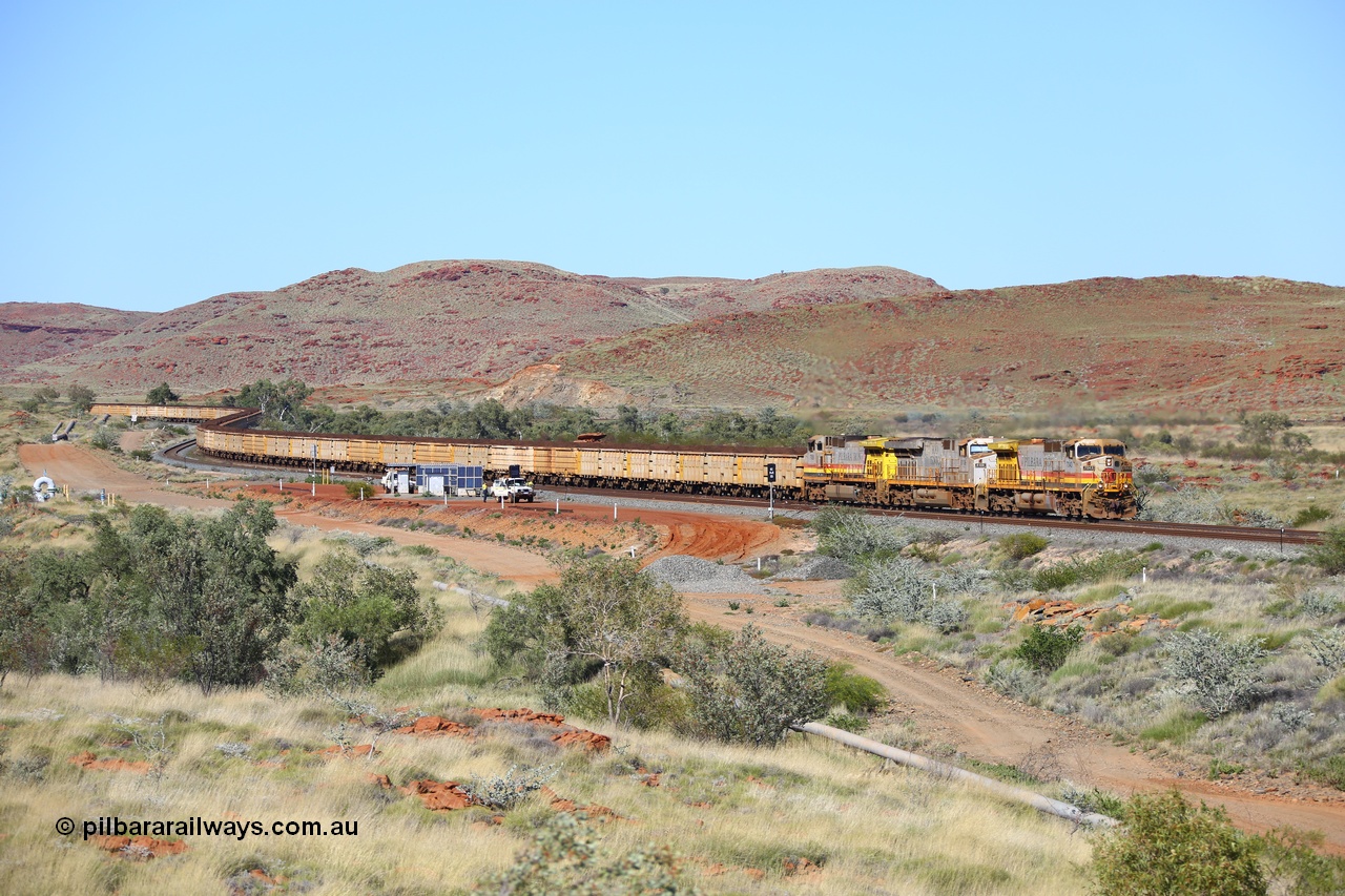 180616 1744
Emu Siding, a loaded train of Q and B series ore waggons behind the lowest numbered Rio Tinto loco 7043 with serial 57094 a GE Erie built GE model Dash 9-44CW from the 10th order in HI Pilbara Iron livery leading an original ES44DCi unit 8108 and sister Dash 9-44CW unit 7058 in the same HI Pilbara Iron livery as they descend the West Mainline past EM7 and EM5 signals at the 74.88 km on they way to Cape Lambert. 16th June 2018. [url=https://goo.gl/maps/fRULDNHPmMo]GeoData[/url].
Keywords: 7043;57094;GE;Dash-9-44CW;HI-Pilbara-Iron;