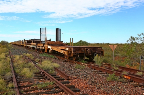 180614 1329
Allen Siding, at the 45 km looking east, the original rail or steel train is stowed on the mainline, looking from 1st lead off waggon 6011, built by Scotts of Ipswich 04-09-1970, the mesh guarding is for the winch cable. The chute arrangement for the discharging and recovery of rail is visible. 14th June 2018. [url=https://goo.gl/maps/UE2dRkZvdBr]GeoData[/url].
