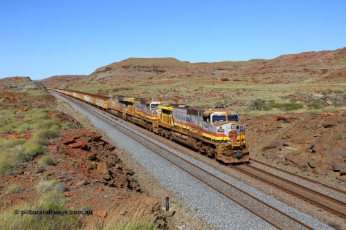 180616 1771
At the 81 km on the Tom Price West mainline, Rio Tinto loco 7056 with serial 55881 a GE Erie built GE model Dash 9-44CW from the 8th order in HI Pilbara Iron livery leads sister 7047 and ES44DCi unit 8115 in Rio Tinto silver with a loaded train of B and Q series waggons operating in AutoHaul™ as they approach Emu and then continue onto Dampier. 16th June, 2018. [url=https://goo.gl/maps/EkqHKXMxSHT2]GeoData[/url].
Keywords: 7056;GE;Dash-9-44CW;55881;HI-Pilbara-Iron;