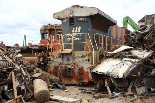 160128 00380
Wedgefield, Sims Metal yard, surrounded by remains, the last unit of 4 GE CM39-8 units built new in 1988 by Goninan WA, 5633 serial 5831-12/88-082 has its back to the scrapping while rebuilt sibling 5636 looks on.
Keywords: 5633;Goninan;GE;CM39-8;5831-12/88-082;