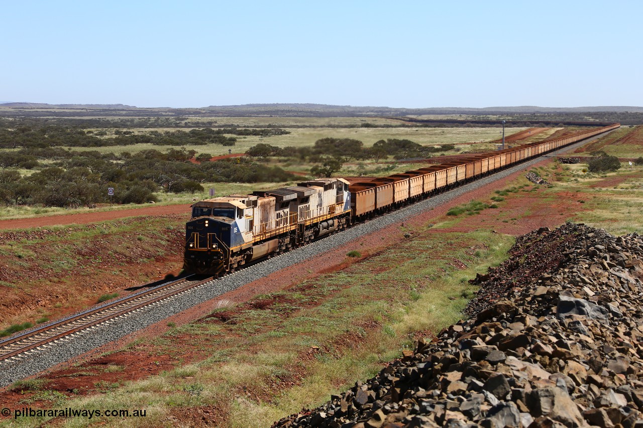 150505 7959
FMG Solomon Line, a pair of General Electric Dash 9-44CW locomotives 005 serial 58182 and 006 serial 58183 struggle upgrade with a loaded train at the 227 km bound for Port Hedland, the train is being assisted in the rear. Geodata: [url=https://goo.gl/maps/NjHo38Gc7kE2] -22.0189283 118.5861050 [/url].
Keywords: FMG-005;GE;Dash-9-44CW;58182;FMG-006;58183;