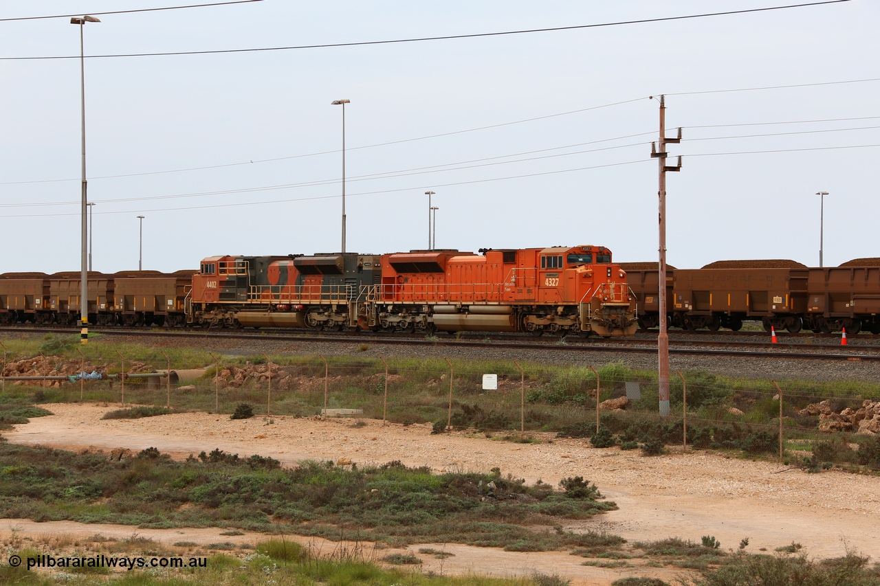 150523 8197
Nelson Point Yard, a pair of BHP Billiton SD70ACe units waits in the arrival yard with a loaded rake for the dumpers. Lead unit 4327 'Hamersley' is from an order originally built by Electro-Motive, London Ontario for BNSF, a US Class 1 railroad, but BHP secured 10 of them during construction, this unit 4327 serial 20066862-056 was destined to be BNSF 9185 before coming to BHP. The second unit 4402 is from a batch of Progress Rail EMD SD70ACe units serial 20118575-012.
