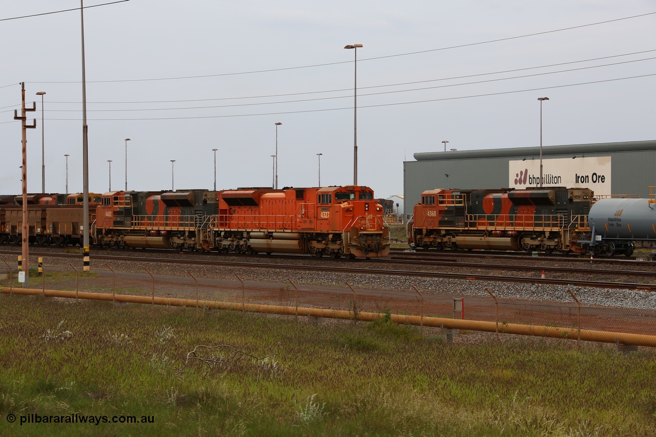 150523 8236
Nelson Point Yard, BHP Billiton SD70ACe unit leads a rake towards the dumpers. Lead unit 4327 'Hamersley' is from an order originally being built by Electro-Motive, London Ontario for BNSF, an US class 1 railroad, but BHP secured 10 of them during construction, this unit 4327 serial no. 20066862-056 was destined to be BNSF 9185 before coming to BHP, passes SD70ACe unit 4368 on the fuel tank shunt, a unit from the last order of 18 SD70ACe units for BHP Billiton from Electro-Motive, London Ontario, serial no. 20098203-013.
