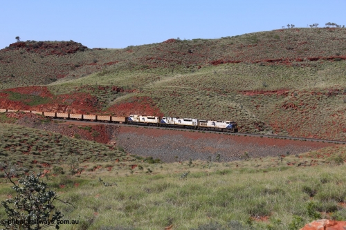 150508 8111
FMG Solomon Line, empty train lead by triple combination of General Electric Dash 9-44CW 004 serial 58181, EMD SD90MAC-H 916 serial 976833-22 and EMD SD70ACe 710 serial 20118693-002 power through the hills around the Bea Bea Creek area. Geodata: [url=https://goo.gl/maps/nBtezda3P8n] -22.0528200 118.7132450 [/url].
