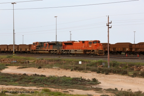 150523 8197
Nelson Point Yard, a pair of BHP Billiton SD70ACe units waits in the arrival yard with a loaded rake for the dumpers. Lead unit 4327 'Hamersley' is from an order originally built by Electro-Motive, London Ontario for BNSF, a US Class 1 railroad, but BHP secured 10 of them during construction, this unit 4327 serial 20066862-056 was destined to be BNSF 9185 before coming to BHP. The second unit 4402 is from a batch of Progress Rail EMD SD70ACe units serial 20118575-012.
