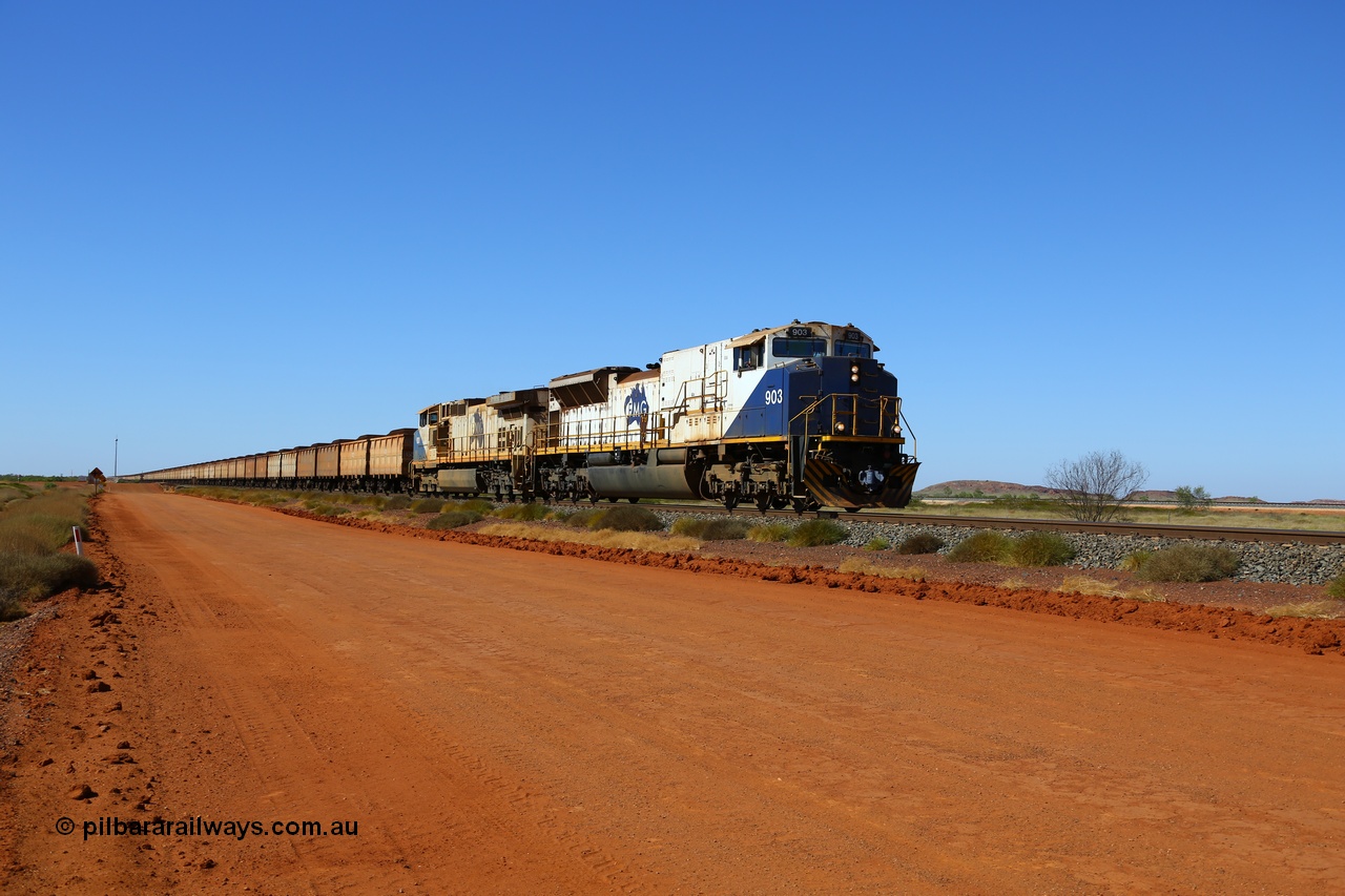 170730 0482
Indee, a loaded FMG iron ore train crosses Indee Rd grade crossing at the 48 km as it runs to the port behind NS Juniata Shops rebuild EMD SD90MAC-H unit 903 serial 976833-18 and General Electric built Dash 9-44CW class leader unit 001. 903 had the 245-H engine replaced with a 710 in 2014. The line to the right is the Roy Hill line. 30th July 2017. [url=https://goo.gl/maps/8SQqrFhdycC2]GeoData[/url].
Keywords: FMG-903;NS-Juniata-Shops;EMD;SD90MAC-H2;976833-18;