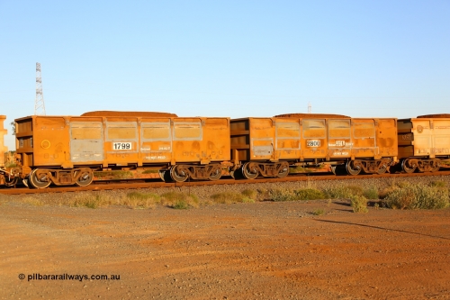 170726 9457
Boodarie, FMG ore waggon pair 2800 (control) and 1799 (slave) of the original design and loaded with fines ore shows evidence of side wall panel replacement and new relining dates. 26th July 2017.
