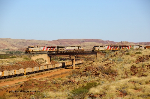 170728 09819
Western Creek, a disabled train from Mesa A on the right behind ES44ACi unit 9103 has relief locos 7082 serial 47761 a General Electric built Dash 9-44CW and a General Electric built ES44DCi unit 8137 ease up to couple onto 9103s disabled train. This image shows all these models of locomotive on the Rio Tinto mainline roster as an empty train climbs upgrade under the bridge. 28th July 2017. [url=https://goo.gl/maps/n4HzBo2eGrz]GeoData[/url].
Keywords: 7082;GE;Dash-9-44CW;47761;