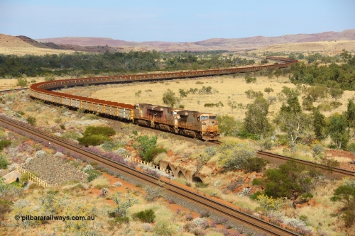 170729 0119
Green Pool, as they cross the #6 bridge on the original Robe River line with their train snaking all the way back to Western Creek, General Electric built ES44DCi unit 8114 serial 59106 in original silver livery and operating in AutoHaul™ with later sister units 8120 and 8148 with a loaded train from Yandicoogina. 29th July 2017. [url=https://goo.gl/maps/hJHqGCy1HKk]GeoData[/url].
Keywords: 8114;GE;ES44DCi;59106;