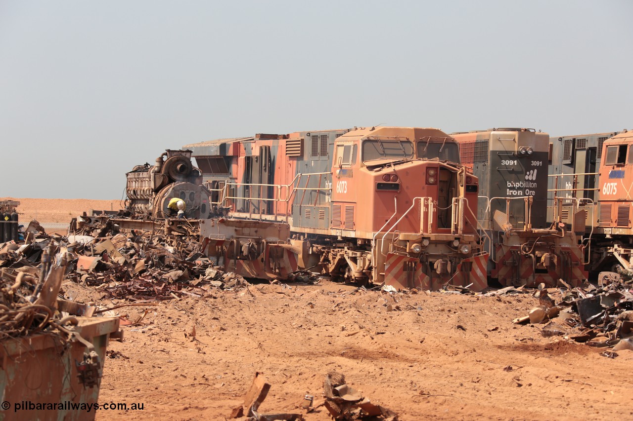 141027 5827
Wedgefield, Sell and Parker's metal recycling yard, with what remains of an SD40R and prime mover having the frame cut into three pieces, as the once mighty GE AC6000 6073 and SD40R 3091 wait their turn to ne reduced to scrap.
Keywords: S+P;6073;GE;AC6000;51065;EMD;SD40R;3091;31496/7861-6;