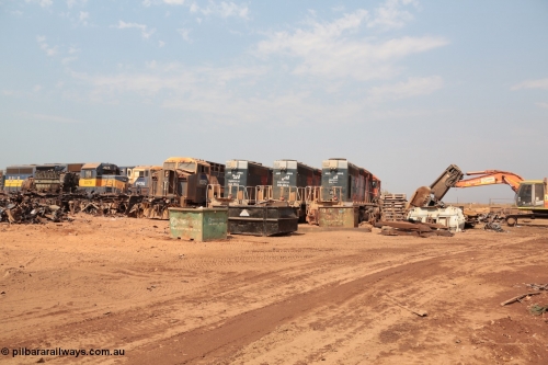 141027 5829
Wedgefield, Sell and Parker's metal recycling yard, overview of the carnage. Units visible awaiting the shears and gas are, EMD SD40 3079, which is behind the frame of GE AC6000 6071, AC6000 6074 and 6072 and SD40R 3092, 3089 and 3095 with a frame part from a former SD40R and the excavator with the hydraulic shears.
