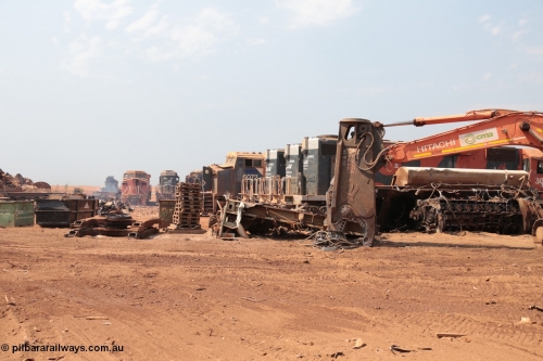 141027 5831
Wedgefield, Sell and Parker's metal recycling yard, overview of the carnage. Units visible awaiting the shears and gas are, GE AC6000 6073, EMD SD40R 3091, AC6000 6072, SD40R 3092, 3089 and 3095 flanked by the remains of an SD40R with the hydraulic shears and EMD 645 engine on its side.
