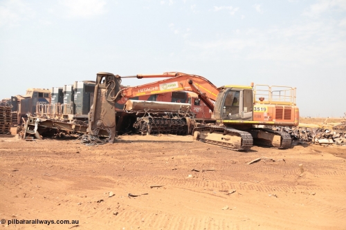141027 5833
Wedgefield, Sell and Parker's metal recycling yard, view of Hitachi ZAXIS 350 LCH excavator fitted with the huge hydraulically operated shears that are making a meal of former EMD SD40 and GE AC6000 locomotives. Behind it lays the remains of an EMD SD40R unit which has been reduced to a few frame part with the EMD 645 engine laying over. Behind it sister units 3095, 3089 and 3092 along with an GE AC6000 6072 wait for a similar fate.

