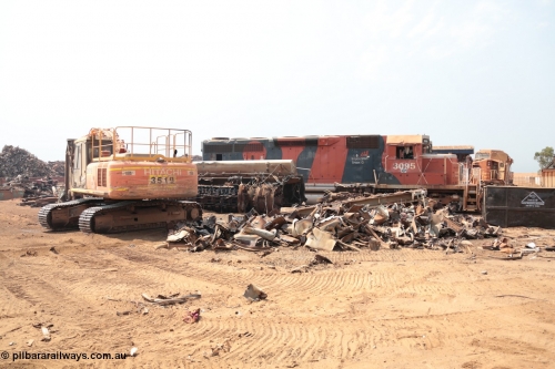 141027 5834
Wedgefield, Sell and Parker's metal recycling yard, view of EMD SD40R unit 3095 serial 33677/7083-7 watching a former sister unit being reduced to bits, a primer mover 645 EMD engine and fuel tank tipped on its side, and the excavator with the hydraulic shears.
Keywords: 3095;EMD;SD40R;33677/7083-7;SD40;SP8485;