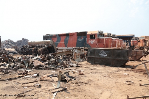 141027 5839
Wedgefield, Sell and Parker's metal recycling yard, view of EMD SD40R unit 3095 serial 33677/7083-7 watching a former sister unit being reduced to bits, a primer mover 645 EMD engine and fuel tank tipped on its side, and the excavator with the hydraulic shears.
Keywords: 3095;EMD;SD40R;33677/7083-7;SD40;SP8485;