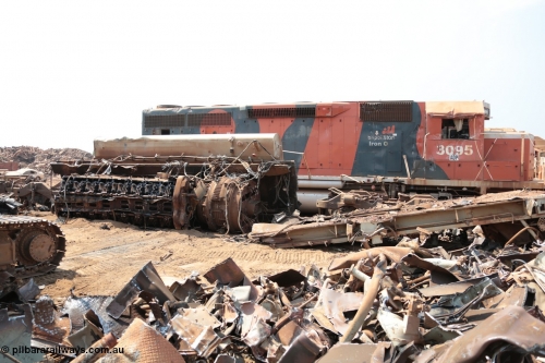141027 5859
Wedgefield, Sell and Parker's metal recycling yard, view of EMD SD40R unit 3095 serial 33677/7083-7 watching a former sister unit being reduced to bits, a primer mover 645 EMD engine and fuel tank tipped on its side, pilot and bogie, and the excavator with the hydraulic shears.
Keywords: 3095;EMD;SD40R;33677/7083-7;SD40;SP8485;