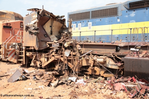 141027 5887
Wedgefield, Sell and Parker's metal recycling yard, General Electric AC6000 unit 6071 serial 51063 is reduced to frame level with only the nose which contains the collision posts awaiting the thermal lance.
Keywords: 6071;GE;AC6000CW;51063;