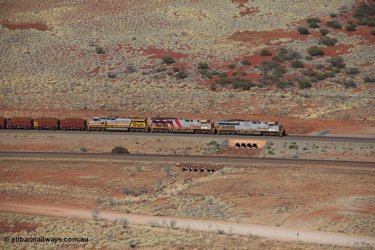 151111 9524
A loaded train behind General Electric ES44DCi units 8113 serial 59105 in the original silver livery and 8145 serial 58726 in the tiger strip Rio livery and Dash 9-44CW 9433 serial 54766 in ROBE Pilbara Iron livery runs over the 54.04 km culvert on the West Mainline bound for Cape Lambert viewed from Table Hill.
Keywords: 8113;GE;ES44DCi;59105;