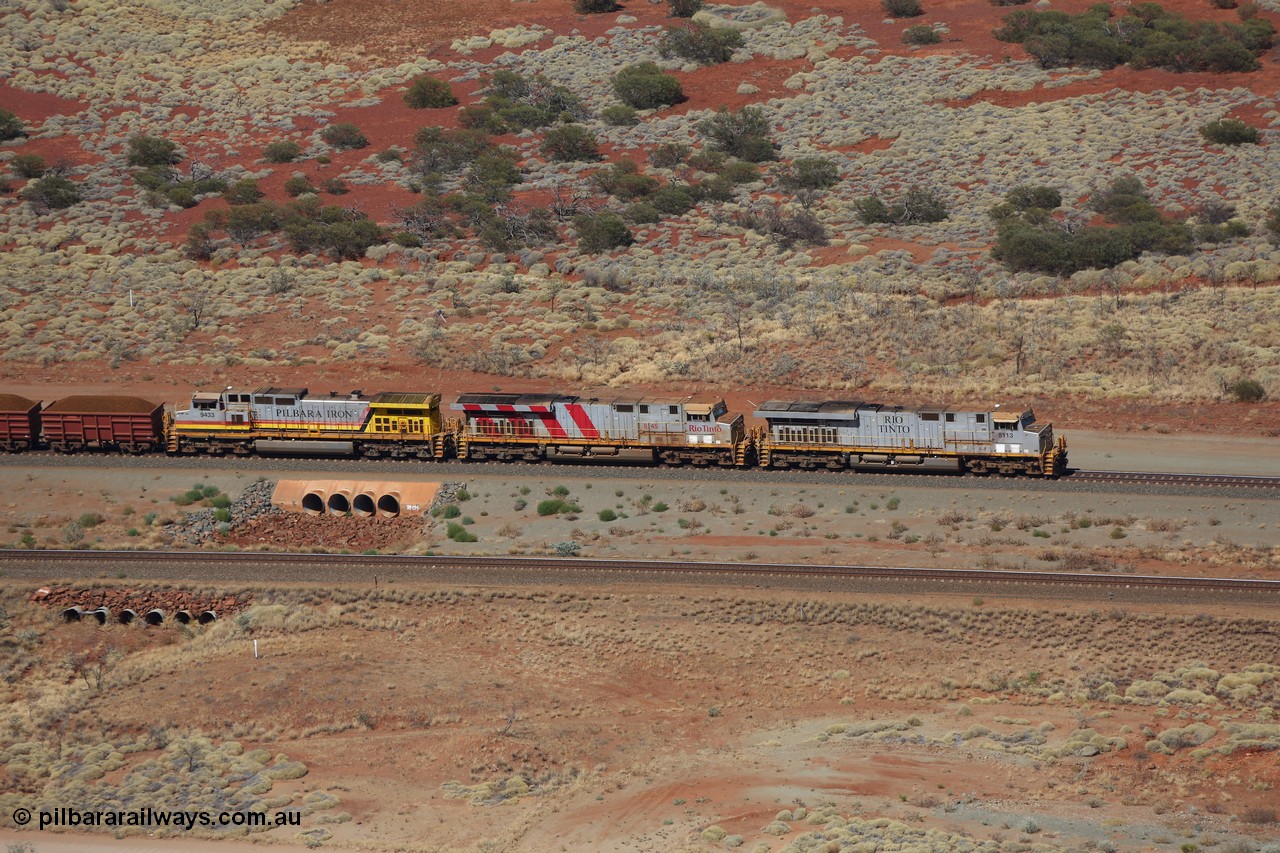 151111 9525
A loaded train behind General Electric ES44DCi units 8113 serial 59105 in the original silver livery and 8145 serial 58726 in the tiger strip Rio livery and Dash 9-44CW 9433 serial 54766 in ROBE Pilbara Iron livery runs over the 54.04 km culvert on the West Mainline bound for Cape Lambert viewed from Table Hill.
Keywords: 8113;GE;ES44DCi;59105;