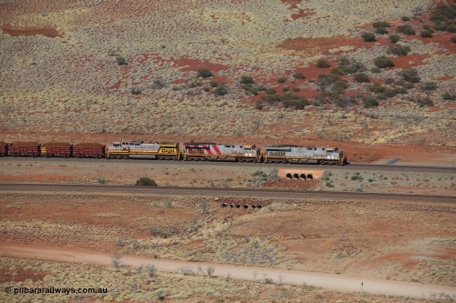 151111 9524
A loaded train behind General Electric ES44DCi units 8113 serial 59105 in the original silver livery and 8145 serial 58726 in the tiger strip Rio livery and Dash 9-44CW 9433 serial 54766 in ROBE Pilbara Iron livery runs over the 54.04 km culvert on the West Mainline bound for Cape Lambert viewed from Table Hill.
Keywords: 8113;GE;ES44DCi;59105;