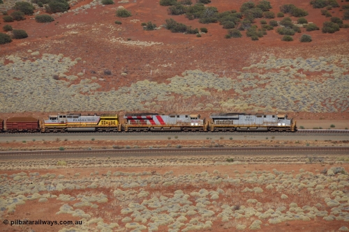 151111 9528
A loaded train behind General Electric ES44DCi units 8113 serial 59105 in the original silver livery and 8145 serial 58726 in the tiger strip Rio livery and Dash 9-44CW 9433 serial 54766 in ROBE Pilbara Iron livery runs along on the West Mainline bound for Cape Lambert viewed from Table Hill.
Keywords: 8113;GE;ES44DCi;59105;