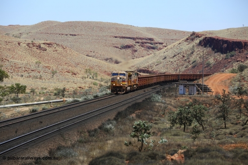 151111 9563
An empty train struggles upgrade at the 84 km post on the Tom Price line behind double General Electric Dash 9-44CW units 9403 serial 53457 wearing ROBE Pilbara Rail livery and 7087 serial 47766 wearing the original Hamersley Iron livery.
Keywords: 9403;GE;Dash-9-44CW;53457;