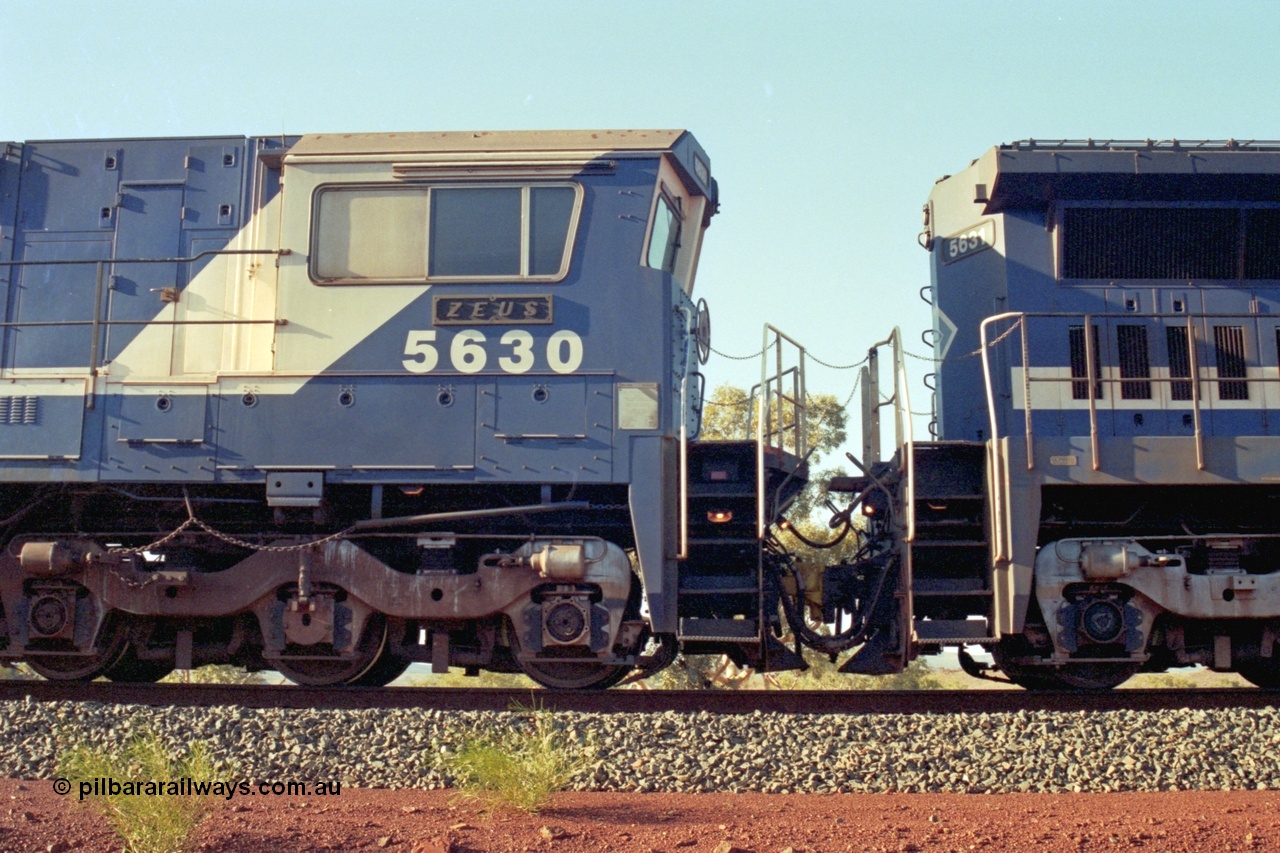 196-07
Yandi Two, BHP Iron Ore 5630 'Zeus' serial 5831-09 / 88-079 originally built new by Goninan as a GE CM39-8 in 1988. Drivers side cab view shows hand brake chain and bogie. May 1998.
Keywords: 5630;Goninan;GE;CM39-8;5831-09/88-079;