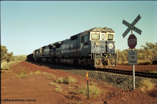 196-02
Yandi Two loaded car side of the loadout balloon loop, BHP Iron Ore CM40-8M or Dash 8 motive power in the form of 5658 'Kakogawa' serial 8412-03 / 94-149 rebuilt by Goninan as GE model CM40-8M from ALCo M636C number 5480 and two new Goninan built GE CM39-8 units 5630 'Zeus' serial 5831-09 / 88-079 and 5631 'Apollo' serial 5831-10 / 88-080 are the head end power with another two CM40-8M units mid-train. Train length is 240 waggons with a 120/120 split. Yandi Two ore stockpile and pedestal stacker boom tip visible in the background, the loadout operates via gravity and the train travels through a tunnel. May 1998.
Keywords: 5658;Goninan;GE;CM40-8M;8412-03/94-149;rebuild;AE-Goodwin;ALCo;M636C;5480;G6061-1;