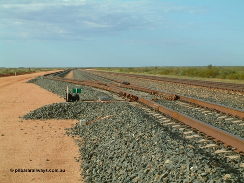 040407 075353
Mooka Siding, looking south with the back track switch and road branching off the passing track, the mainline is on the right. 7th April 2004.
