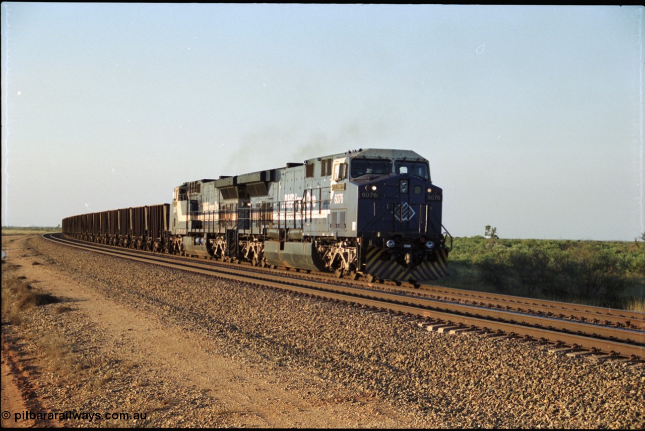 203-03
Bing Siding, an empty train behind a pair of BHP General Electric AC6000 units 6076 'Mt Goldsworthy' serial 51068 and class leader 6070 'Port Hedland' serial 51062 run around the passing track up to the departure signal.
Keywords: 6076;GE;AC6000;51068;