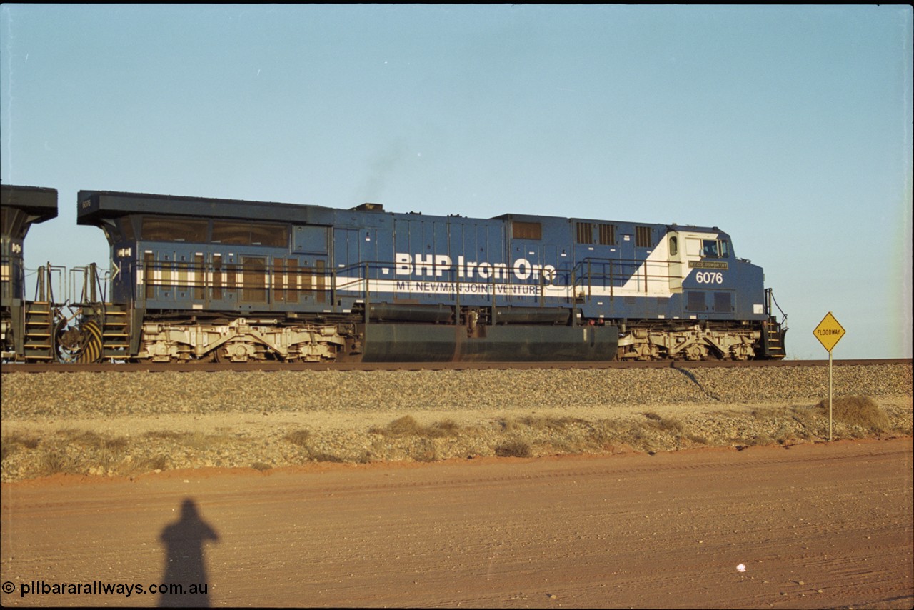 203-05
Bing Siding, BHP General Electric built AC6000 unit 6076 'Mt Goldsworthy' serial 51068 in the passing track with a Yandi empty working.
Keywords: 6076;GE;AC6000;51068;