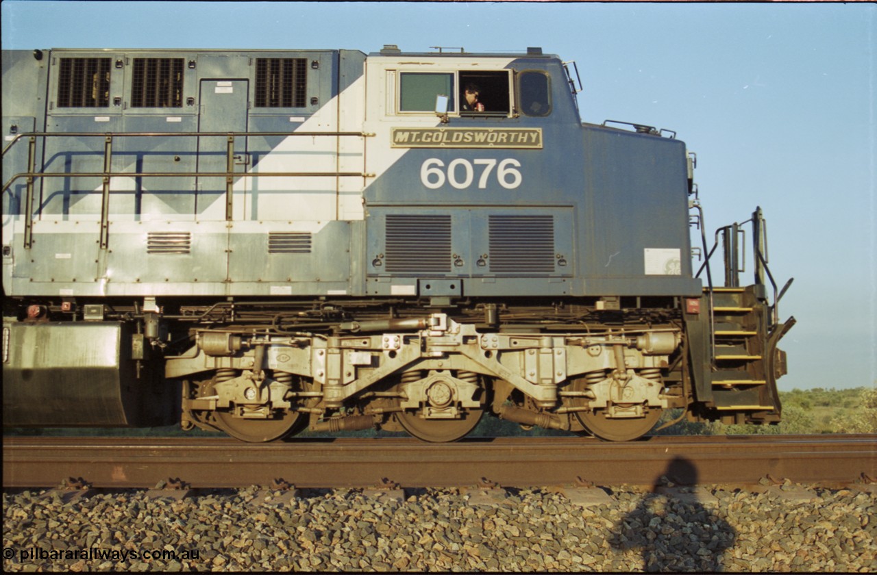 203-11
Bing Siding, BHP Iron Ore General Electric AC6000 model 6076 'Mt Goldsworthy' serial 51068 with an empty train. Cab side view with name board, steerable bogie and Driver Cosgrove at the controls.
Keywords: 6076;GE;AC6000;51068;