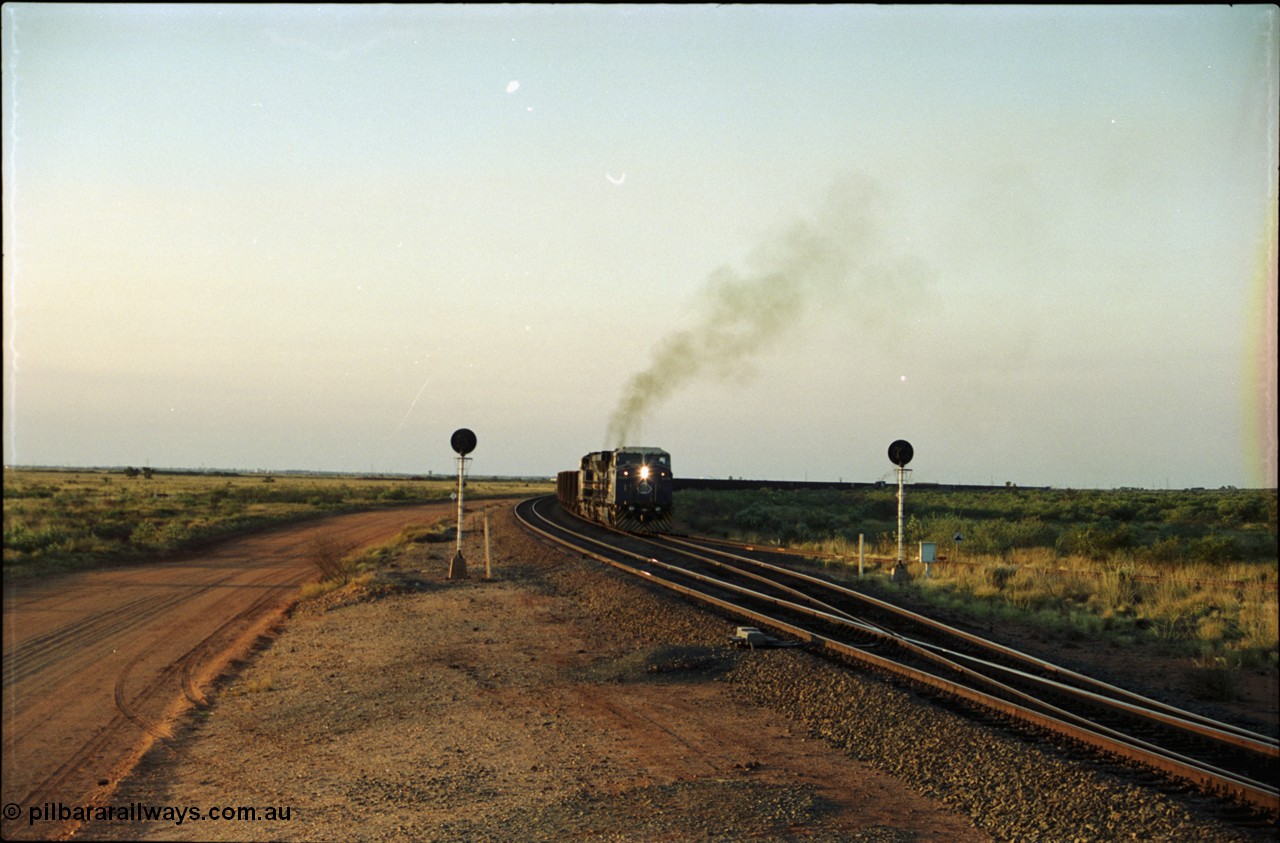 203-17
Bing Siding, with the empty clear, BHP General Electric AC6000 unit 6076 'Mt Goldsworthy' serial 51068 powers its' train out of the passing track at Bing South.
Keywords: 6076;GE;AC6000;51068;
