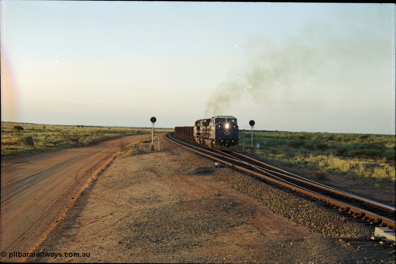 203-18
Bing Siding, with the empty clear, BHP General Electric AC6000 unit 6076 'Mt Goldsworthy' serial 51068 powers its' train out of the passing track at Bing South.
Keywords: 6076;GE;AC6000;51068;