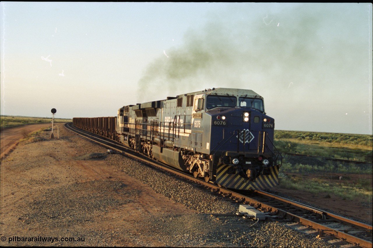 203-20
Bing Siding, with the empty clear, BHP General Electric AC6000 unit 6076 'Mt Goldsworthy' serial 51068 leading class leader 6070 'Port Hedland' serial 51062 as they power their train out of the passing track at Bing South.
Keywords: 6076;GE;AC6000;51068;
