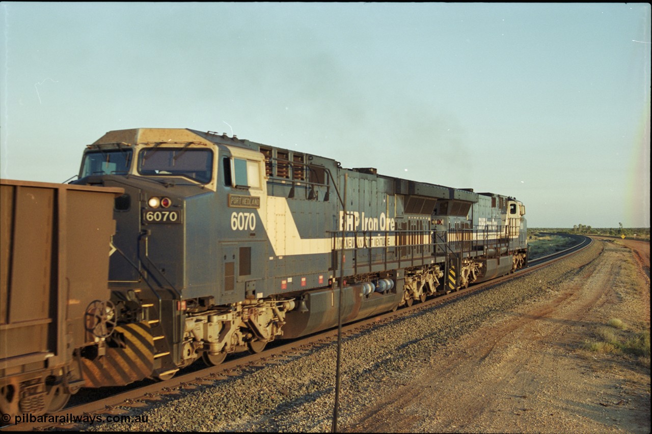 203-21
Bing Siding, with the empty clear, BHP General Electric AC6000 unit 6076 'Mt Goldsworthy' serial 51068 leading class leader 6070 'Port Hedland' serial 51062 as they power their train out of the passing track at Bing South.
Keywords: 6070;GE;AC6000;51062;