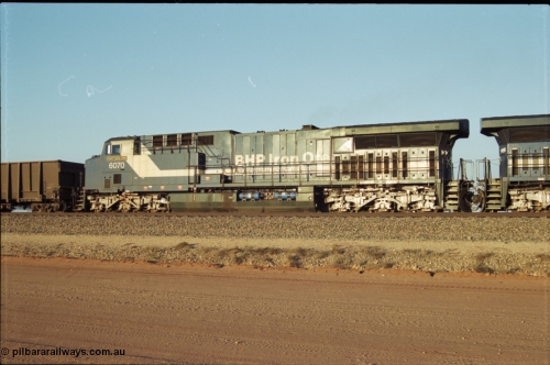 203-04
Bing Siding, BHP General Electric built AC6000 class leader 6070 'Port Hedland' serial 51062 in the passing track as second unit on a Yandi empty working. The size of the BHP AC6000 model radiator is clearly evident here.
Keywords: 6070;GE;AC6000CW;51062;