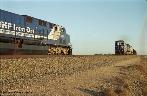 203-13
Bing Siding, a loaded BHP Iron Ore train with a pair of CM40-8M units on the lead are on the mainline as the cross the empty train behind General Electric AC6000 unit 6076 'Mt Goldsworthy' serial 51068.
Keywords: 6076;GE;AC6000CW;51068;
