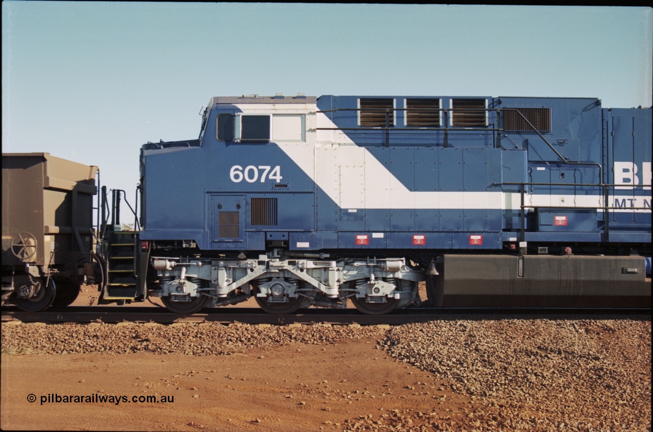 207-11
BHP General Electric built AC6000 unit 6074 serial 51066, brand new and unnamed at Yandi One load-out loop as a remote mid-train unit, view of the left hand side cab and steerable bogie.
Keywords: 6074;GE;AC6000;51066;