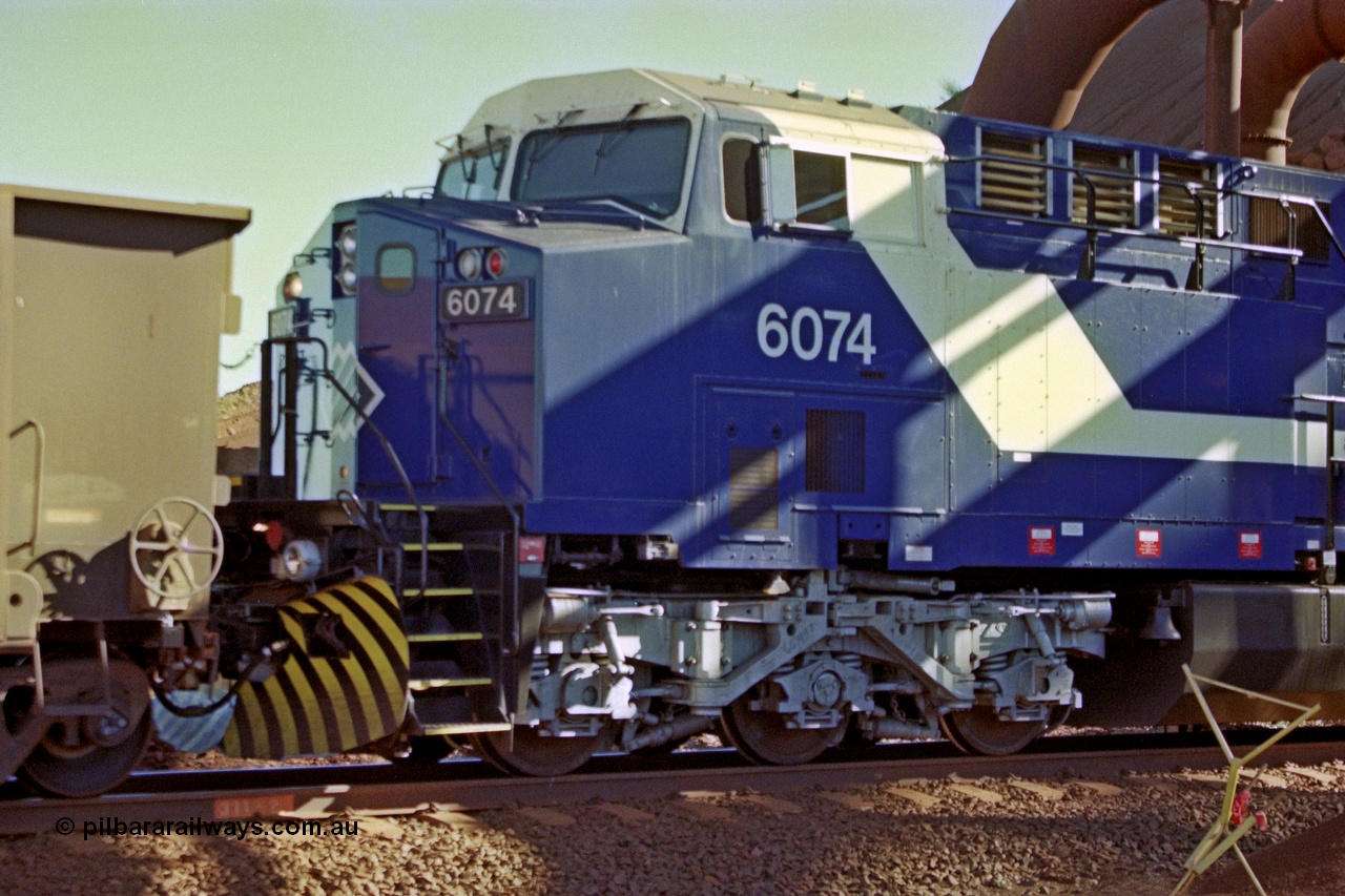 207-17
BHP General Electric built AC6000 unit 6074 serial 51066, brand new and unnamed at Yandi One load-out loop as a remote mid-train unit, view of the left hand side cab and steerable bogie.
Keywords: 6074;GE;AC6000;51066;