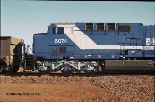 207-11
BHP General Electric built AC6000 unit 6074 serial 51066, brand new and unnamed at Yandi One load-out loop as a remote mid-train unit, view of the left hand side cab and steerable bogie.
Keywords: 6074;GE;AC6000CW;51066;