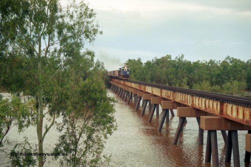 218-08
De Grey River Bridge, a loaded Yarrie train crosses the river behind an original Mt Newman Mining ALCo to GE rebuild carried out by Goninan, originally ALCo C636 5458 to GE model C36-7M unit 5510 'Newman' serial 4839-07 / 87-075.
Keywords: 5510;Goninan;GE;C36-7M;4839-07/87-075;rebuild;AE-Goodwin;ALCO;C636;5458;G6027-2;