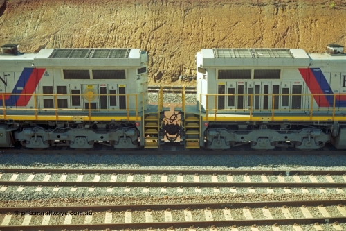 218-34
Yandicoogina or HIY as Hamersley Iron identify it, located 445 km from Parker Point yard in Dampier. Bank engine units General Electric Dash 9-44CW models 7089 serial 47768 on the right coupled to 7090 serial 47769 shows the radiator section and bogies of both units.
Keywords: 7090;GE;Dash-9-44CW;47769;