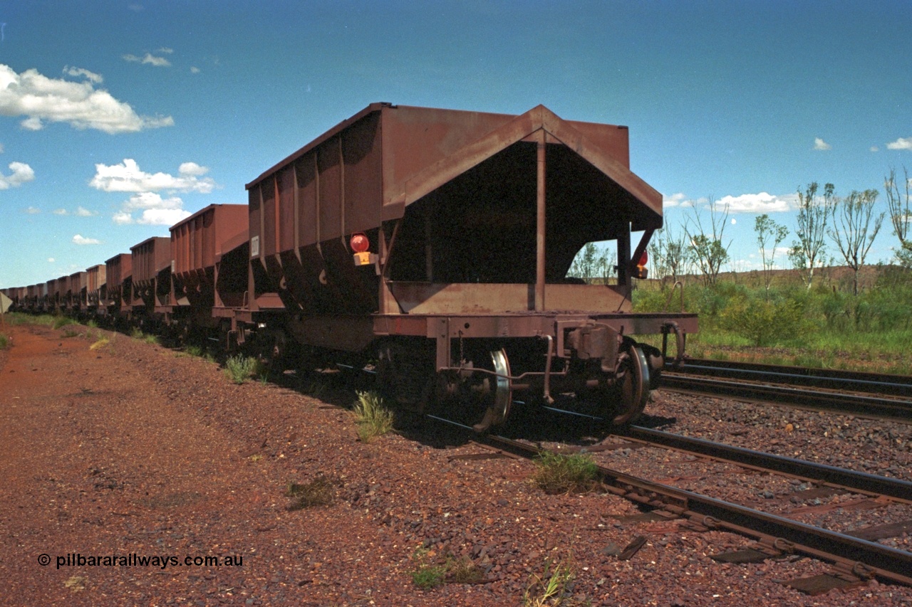 219-32
Goldsworthy Siding, the rear of an empty train sits in the siding awaiting a meet. The waggons in view were designed by AE Goodwin and built by Scott's of Ipswich and Tomlinson Steel Perth.
Keywords: Tomlinson-Steel-WA;BHP-ore-waggon;