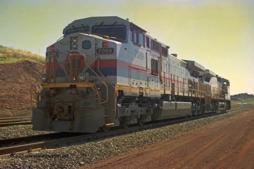 219-13
Yandicoogina or HIY as Hamersley Iron identify it, located 445 km from Parker Point yard in Dampier. Bank engine units General Electric Dash 9-44CW models 7089 serial 47768 and 7090 idle away waiting their next loaded train to push out, the mine is visible in the background.
Keywords: 7089;GE;Dash-9-44CW;47768;