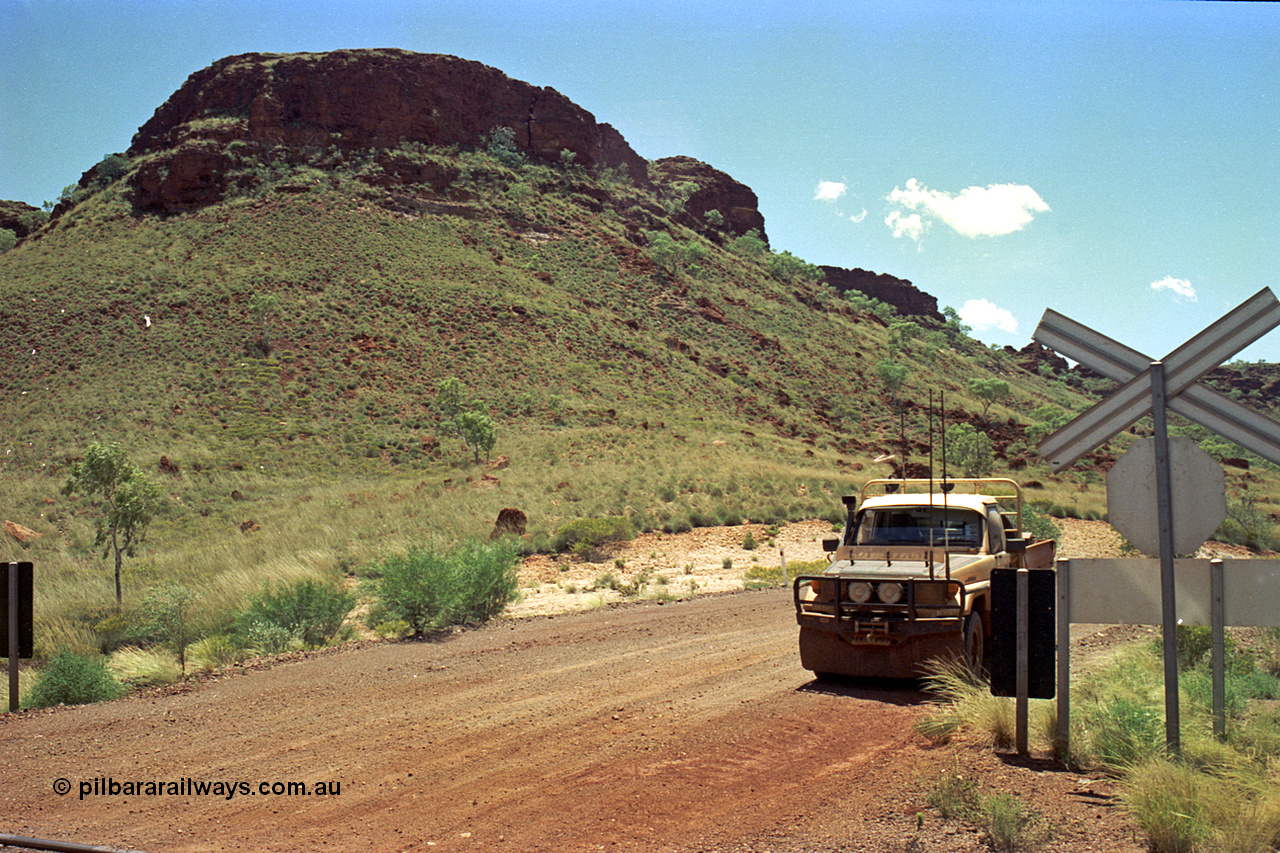 220-12
Shay Gap, Mable Bar Rd grade crossing at the 187.6 km on the line to Yarrie, hills, Toyota HJ75 Landcruiser.
