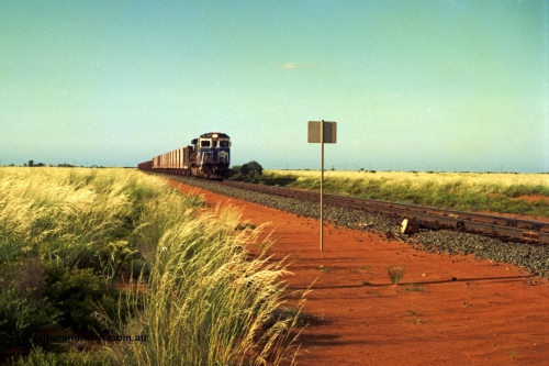 220-22
Goldsworthy Junction, a loaded train from Yarrie mine lead by BHP Dash 7 unit 5507 'Nimingarra' serial 4839-03 / 87-072 was rebuilt by Goninan WA from an ALCo C636 unit 5461 into GE model C36-7M in 1987.
Keywords: 5507;Goninan;GE;C36-7M;4839-03/87-072;rebuild;AE-Goodwin;ALCo;C636;5461;G6035-2;