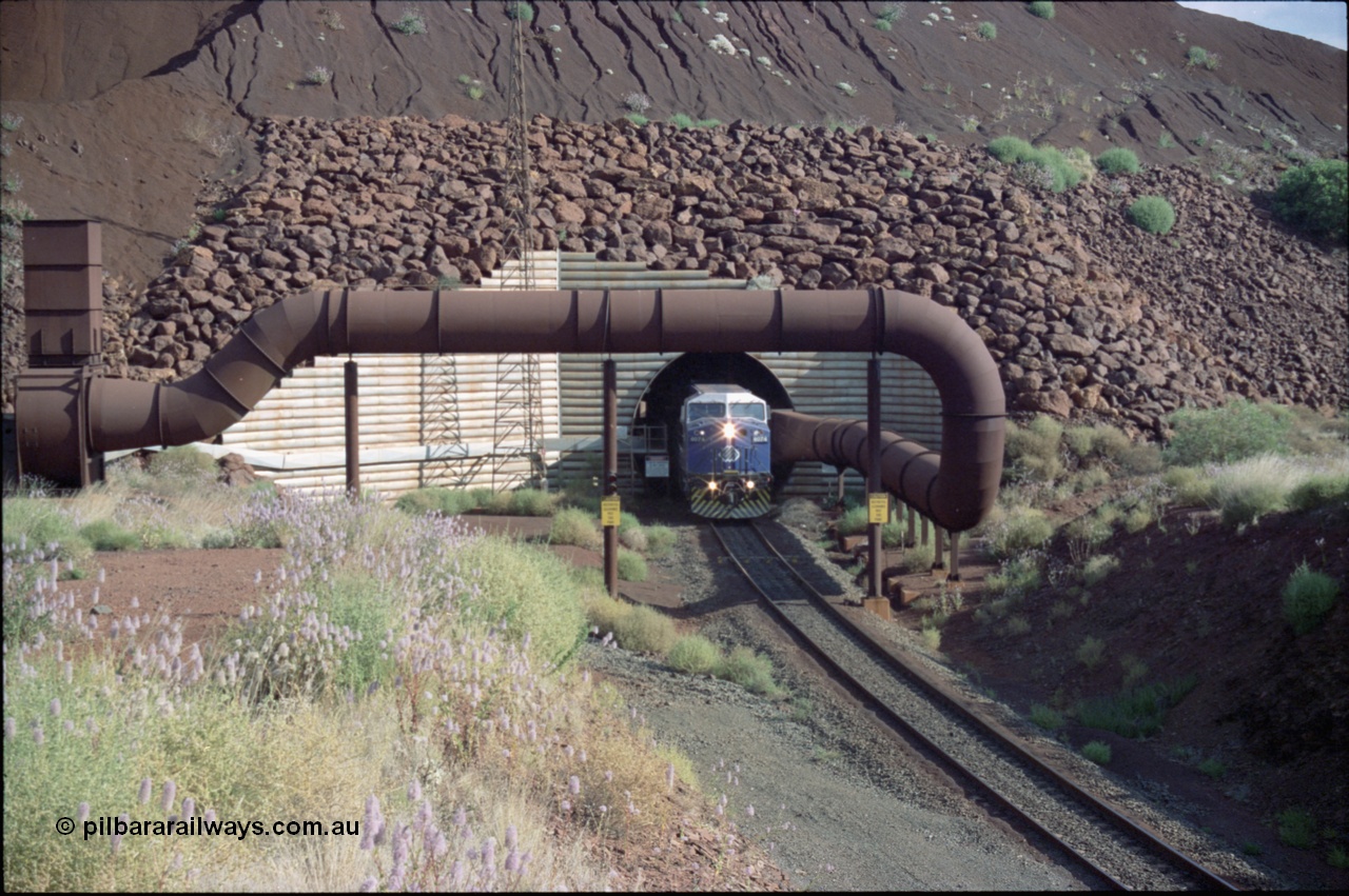 221-23
Yandi One mine loadout balloon loop, General Electric AC6000 class emerges from the loadout portal at 0.9 km/h as it leads a train through the loading vaults, the dust extraction ducting is also visible.
Keywords: GE;AC6000;51062-9;
