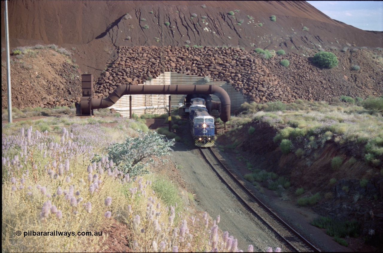 221-26
Yandi One mine loadout balloon loop, General Electric AC6000 class emerges from the loadout portal at 0.9 km/h as it leads a train through the loading vaults, the dust extraction ducting is also visible.
Keywords: GE;AC6000;51062-9;