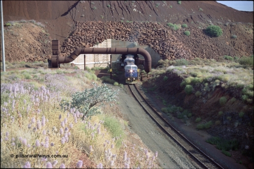221-25
Yandi One mine loadout balloon loop, General Electric AC6000 class emerges from the loadout portal at 0.9 km/h as it leads a train through the loading vaults, the dust extraction ducting is also visible.
Keywords: GE;AC6000;51062-9;